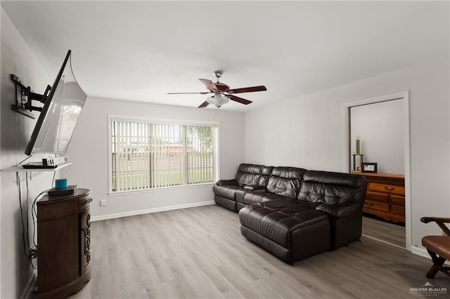 living room featuring ceiling fan and light hardwood / wood-style floors