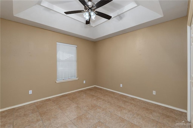 2106 Quail Ln, Mission, TX 78572 - spare room with a raised ceiling, a ceiling fan, and baseboards