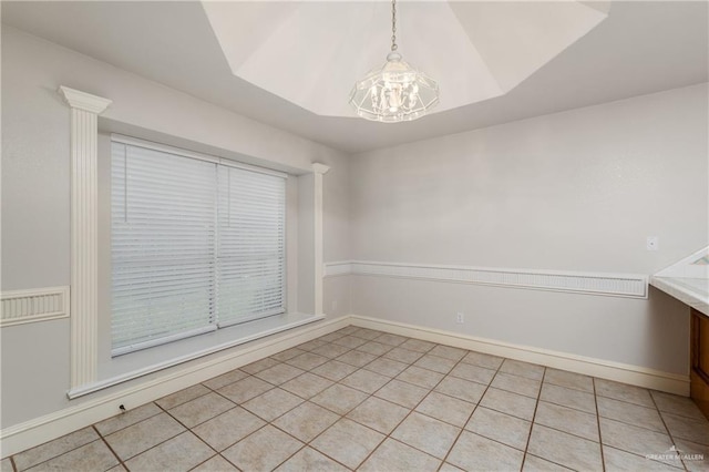 2106 Quail Ln, Mission, TX 78572 - unfurnished room featuring light tile patterned floors, a chandelier, and baseboards