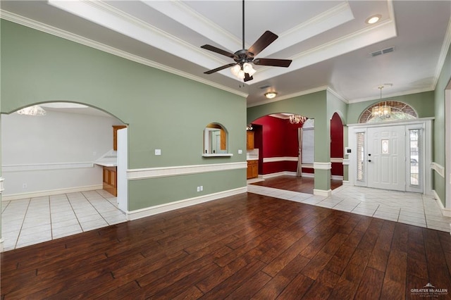 2106 Quail Ln, Mission, TX 78572 - foyer entrance featuring wood-type flooring, a raised ceiling, arched walkways, crown molding, and ceiling fan