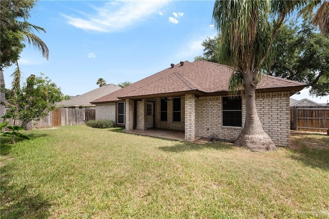 2106 Quail Ln, Mission, TX 78572 - back of property with a patio, brick siding, and roof with shingles