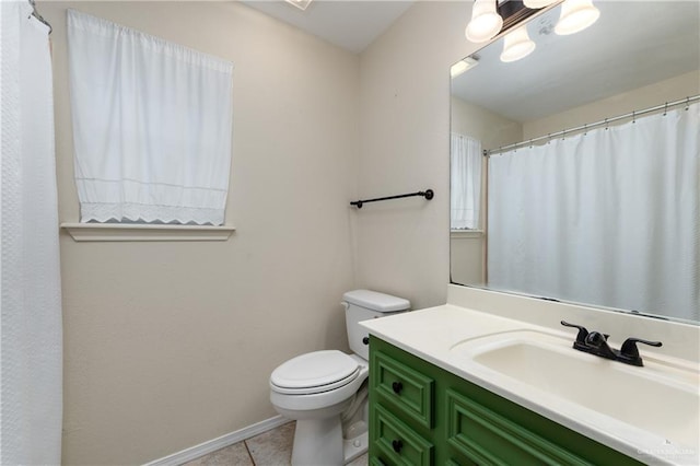 2106 Quail Ln, Mission, TX 78572 - full bath with toilet, vanity, tile patterned flooring, and baseboards