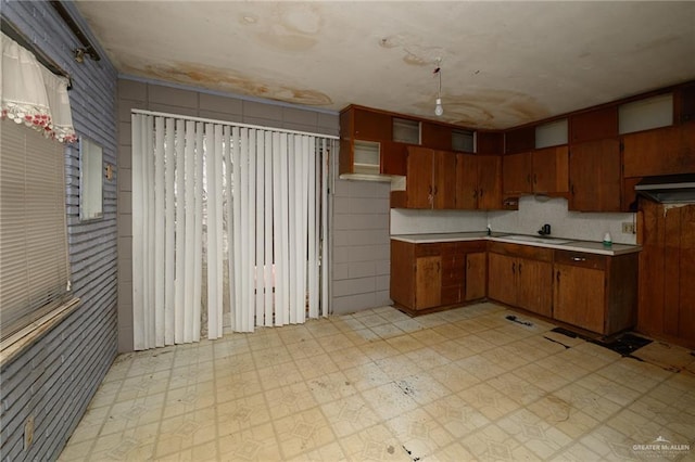 kitchen featuring light countertops, brown cabinets, and light floors