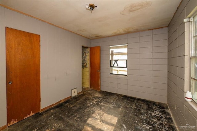 unfurnished room featuring crown molding