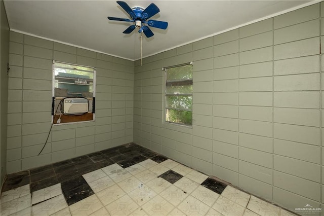 full bathroom with ceiling fan, tiled shower, and ornamental molding