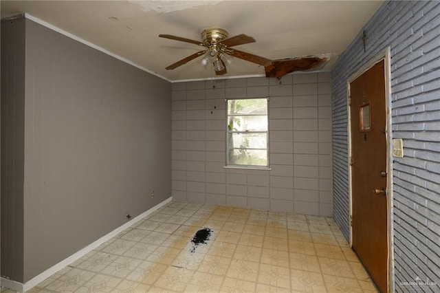spare room featuring a ceiling fan, baseboards, and ornamental molding