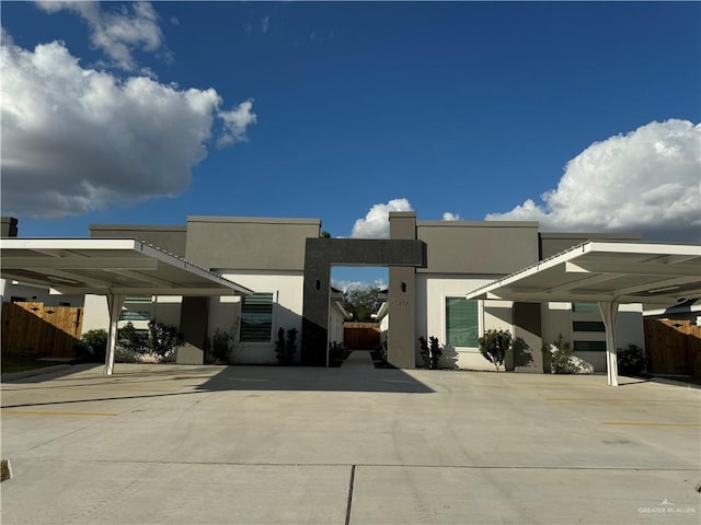 back of house featuring a carport