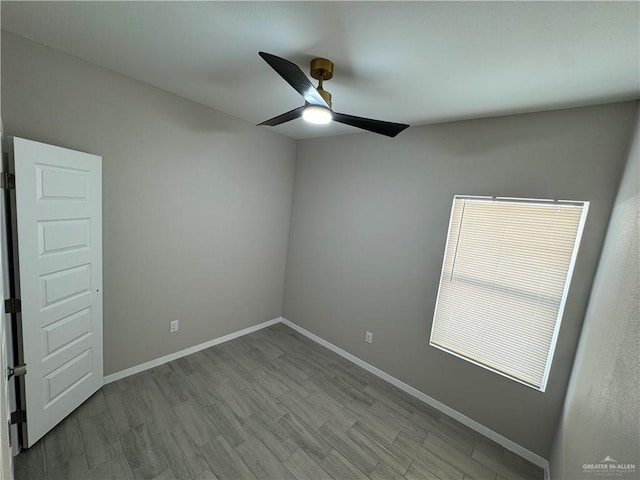 spare room with ceiling fan and light wood-type flooring