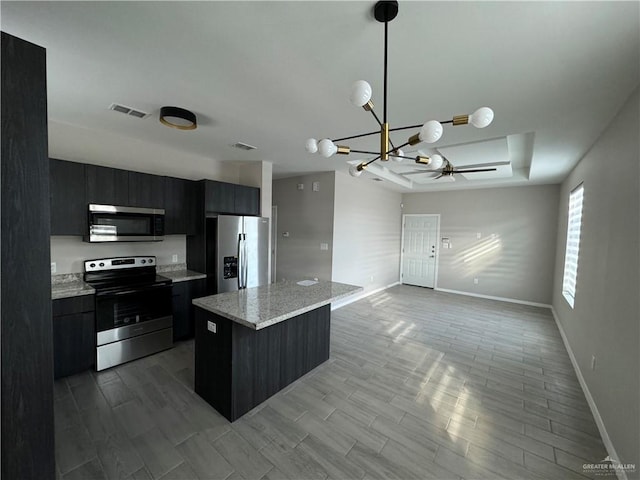 kitchen with stainless steel appliances, an inviting chandelier, pendant lighting, a breakfast bar area, and light wood-type flooring