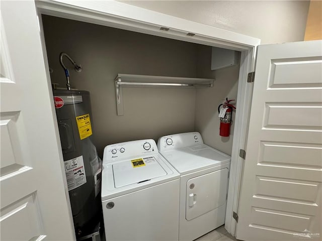 laundry area with washing machine and clothes dryer and water heater