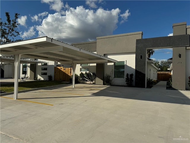 view of parking / parking lot featuring a carport