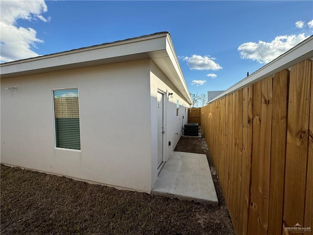 view of side of property featuring central air condition unit