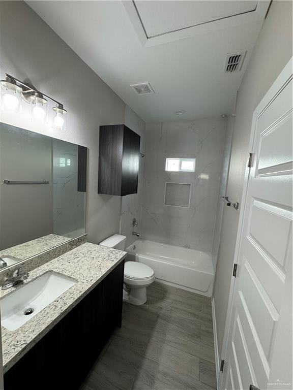 full bathroom featuring vanity, toilet, and tiled shower / bath