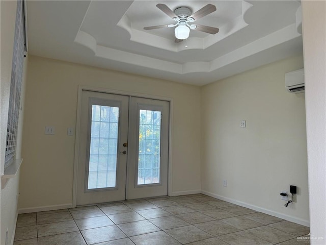 doorway featuring french doors, a tray ceiling, ceiling fan, a wall mounted AC, and light tile patterned flooring