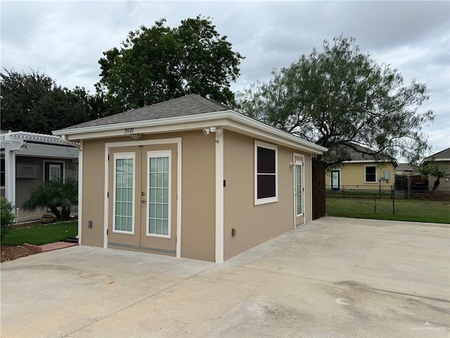 view of home's exterior with french doors, an outdoor structure, and a patio area