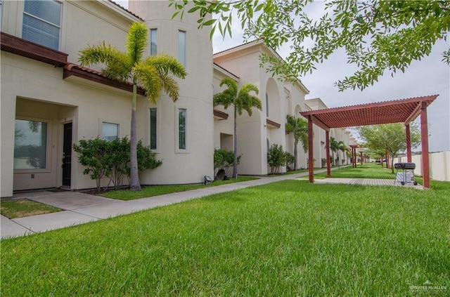 surrounding community featuring a yard and a pergola