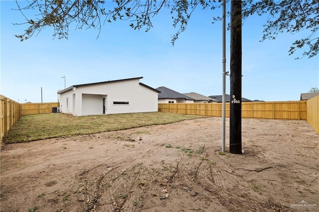 view of yard featuring a fenced backyard and central AC unit