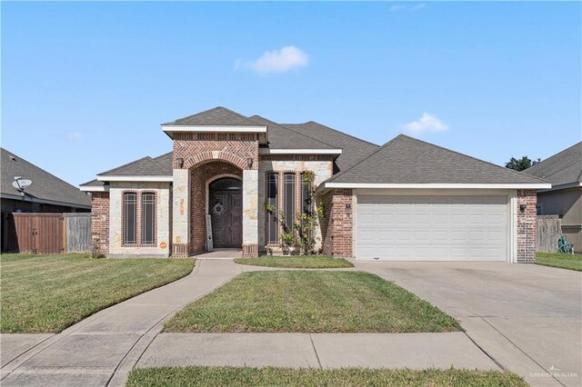 view of front of property featuring a garage and a front lawn