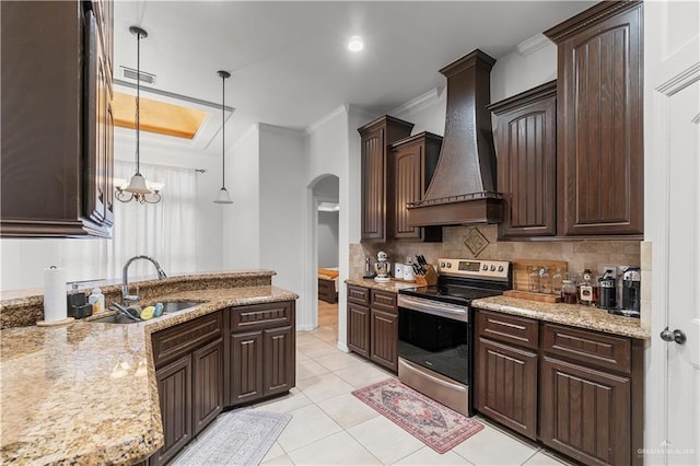 kitchen featuring custom exhaust hood, dark brown cabinetry, sink, pendant lighting, and stainless steel electric range