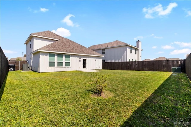 back of property featuring a lawn, central AC unit, a fenced backyard, and a shingled roof