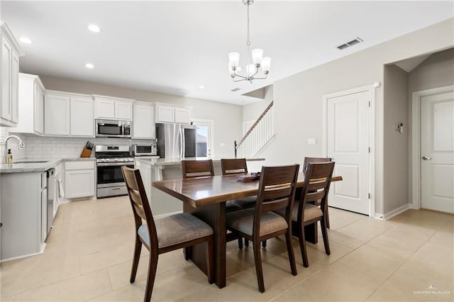 dining area with light tile patterned flooring, recessed lighting, visible vents, and a chandelier