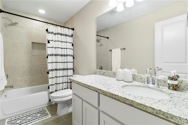 bathroom featuring visible vents, toilet, shower / bath combo with shower curtain, tile patterned floors, and vanity