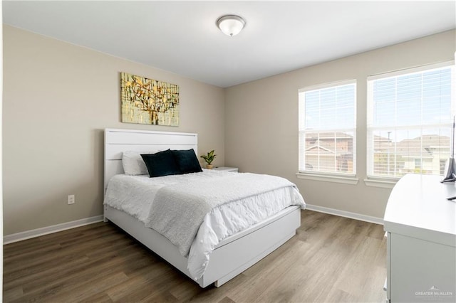 bedroom with baseboards and light wood-style flooring