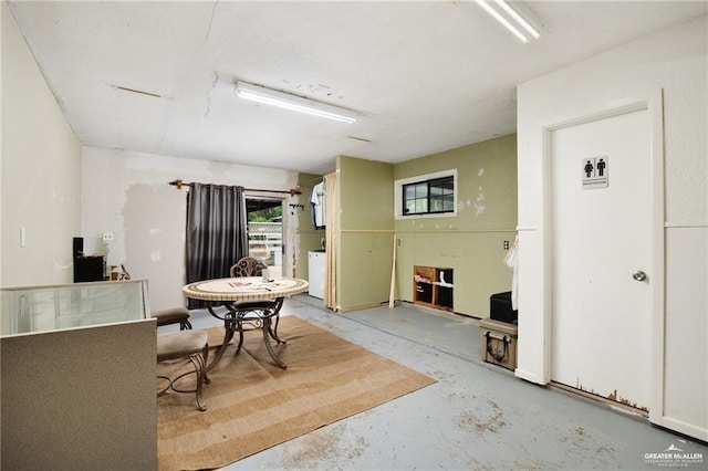 dining area with unfinished concrete flooring