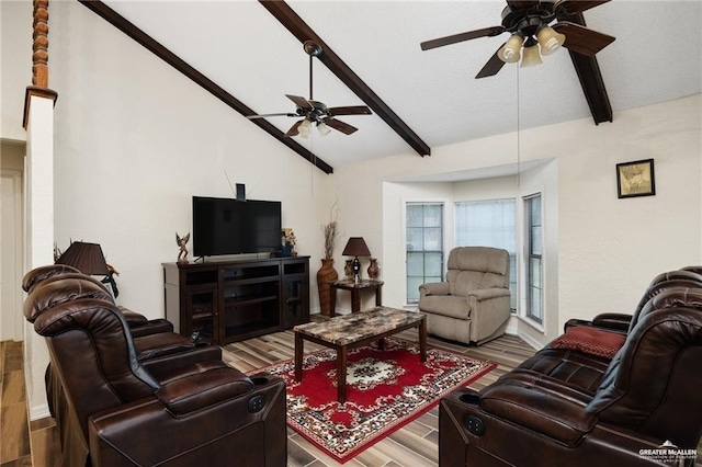 living room with lofted ceiling with beams, ceiling fan, and wood finished floors