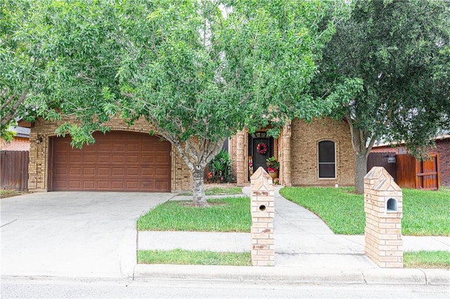 view of front of property with fence, driveway, and brick siding