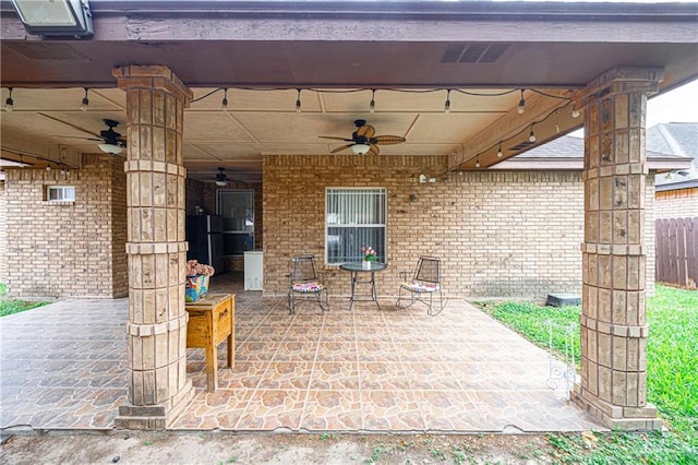 view of patio with ceiling fan, visible vents, and fence