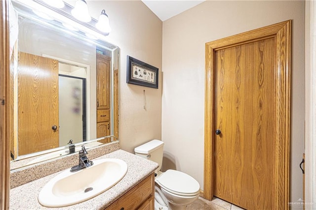 full bath featuring vanity, tile patterned floors, a stall shower, and toilet