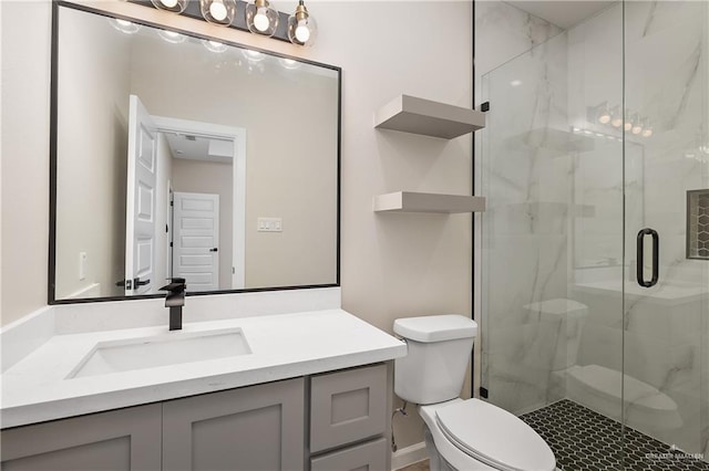 bathroom with toilet, vanity, and a marble finish shower