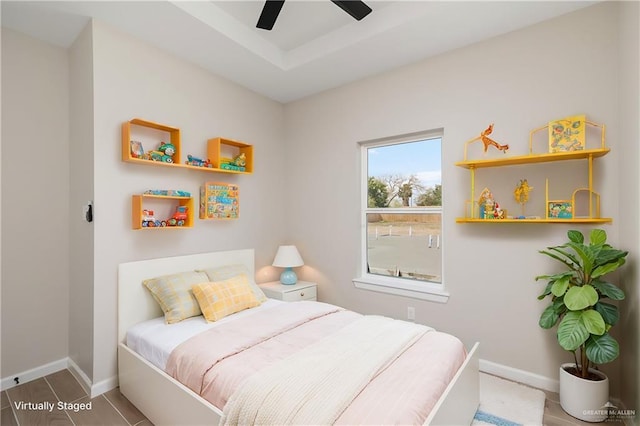 bedroom with a ceiling fan and baseboards