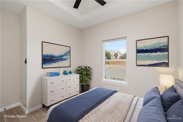 bedroom with ceiling fan and baseboards