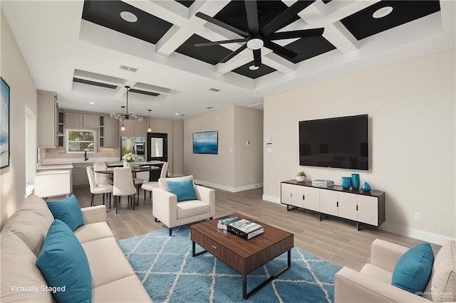 living room featuring a chandelier, baseboards, visible vents, and wood tiled floor