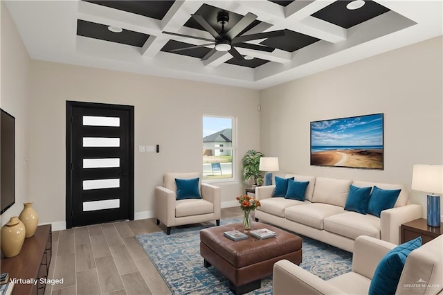 living area featuring coffered ceiling, beamed ceiling, light wood-style flooring, and baseboards