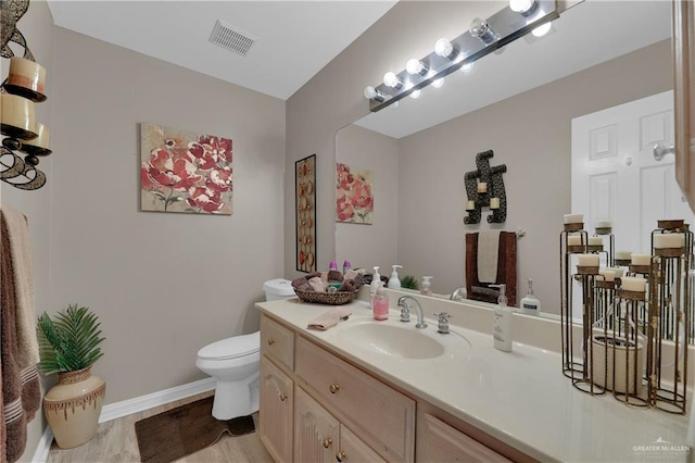 3116 E Alberta Rd, Edinburg, TX 78542 - bathroom with hardwood / wood-style floors, vanity, and toilet