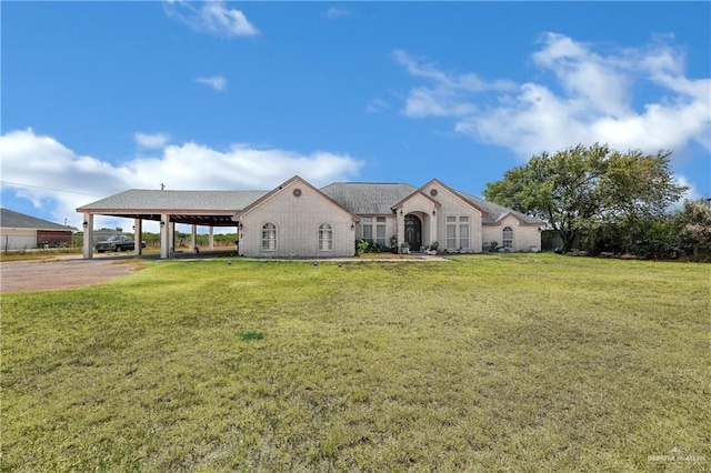 view of front facade with a front yard and a carport