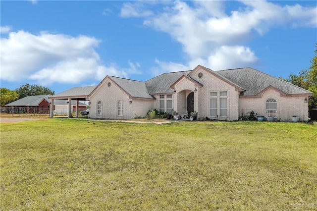 view of front facade featuring a carport and a front lawn