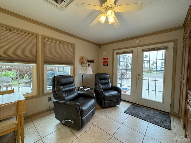 living area featuring light tile patterned floors, visible vents, baseboards, ornamental molding, and french doors