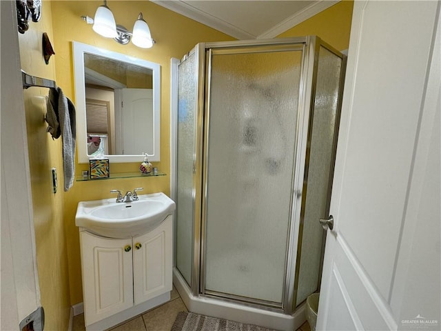 full bath with ornamental molding, a stall shower, tile patterned flooring, and vanity