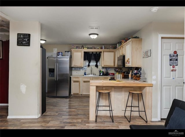 9913 Daniec St, Edinburg, TX 78542 - kitchen with stainless steel fridge with ice dispenser, black microwave, a sink, and light brown cabinetry