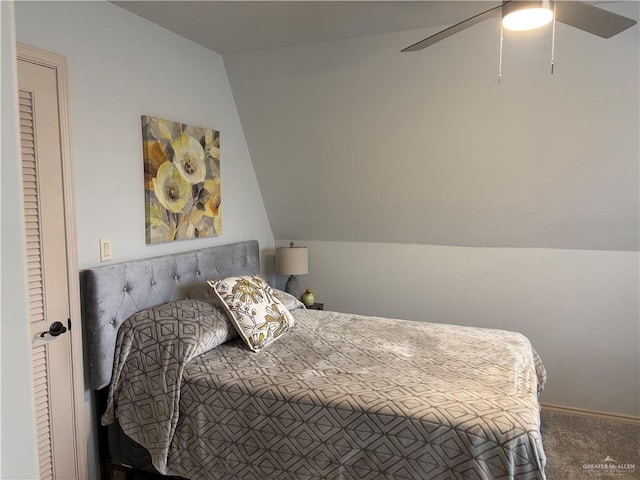 bedroom with vaulted ceiling, ceiling fan, and carpet