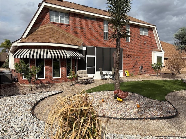 back of house featuring central AC unit