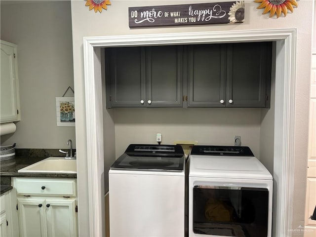 washroom with separate washer and dryer, sink, and cabinets