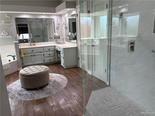 bathroom with vanity, wood-type flooring, and separate shower and tub