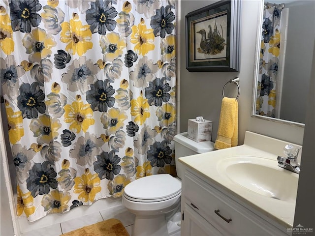 bathroom featuring vanity, tile patterned flooring, and toilet