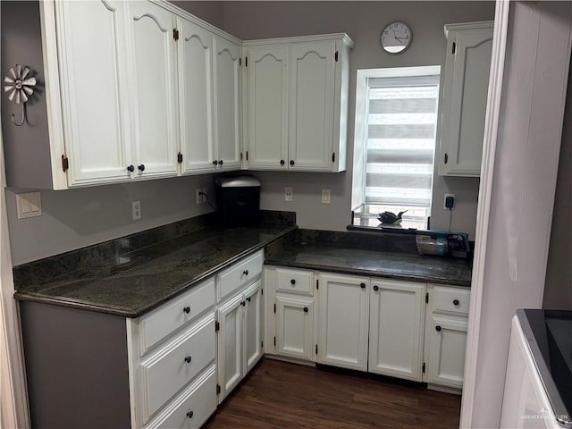 kitchen with dark hardwood / wood-style flooring and white cabinets