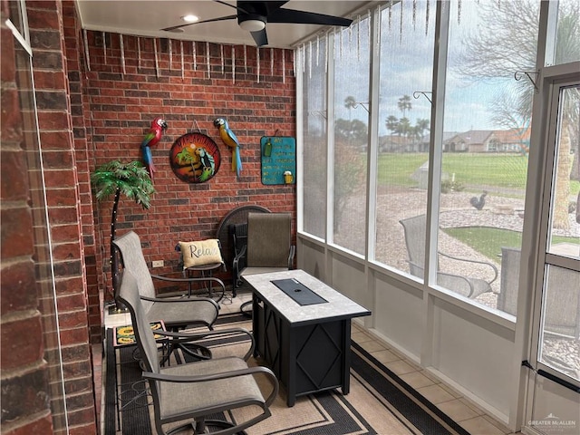 sunroom with a healthy amount of sunlight and ceiling fan